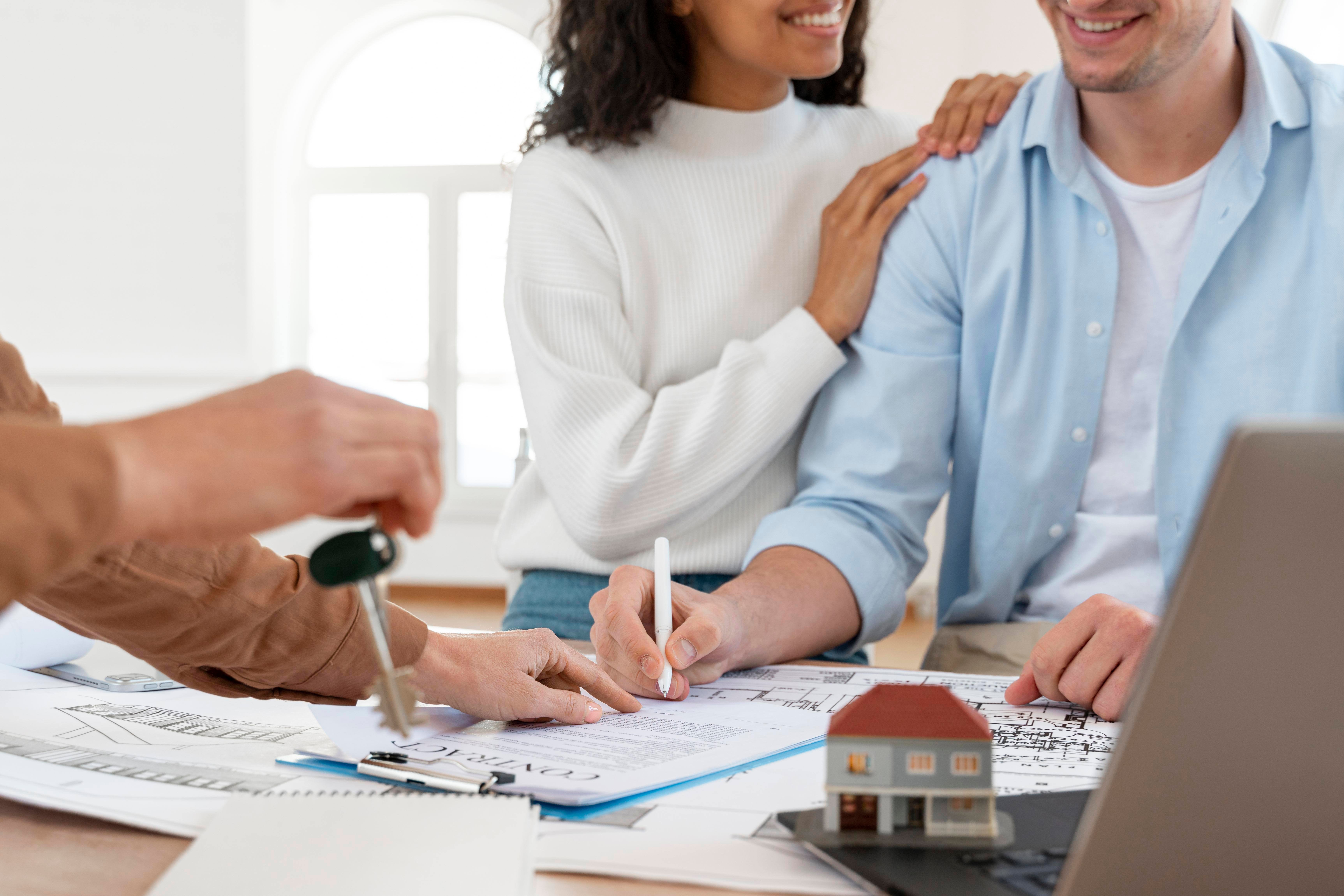 smiley-couple-signing-contract-new-house